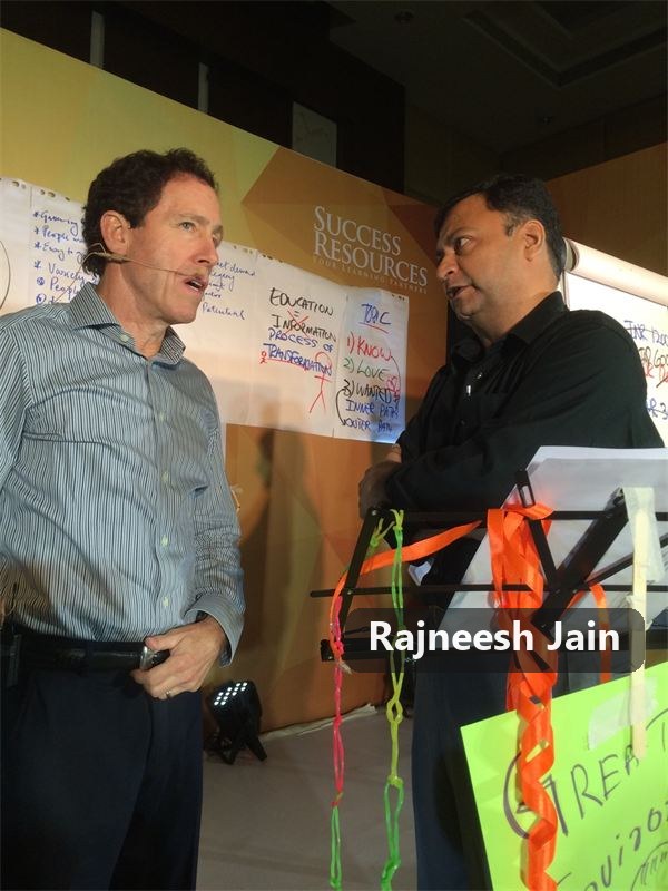 Rajneesh Jain speaking on stage